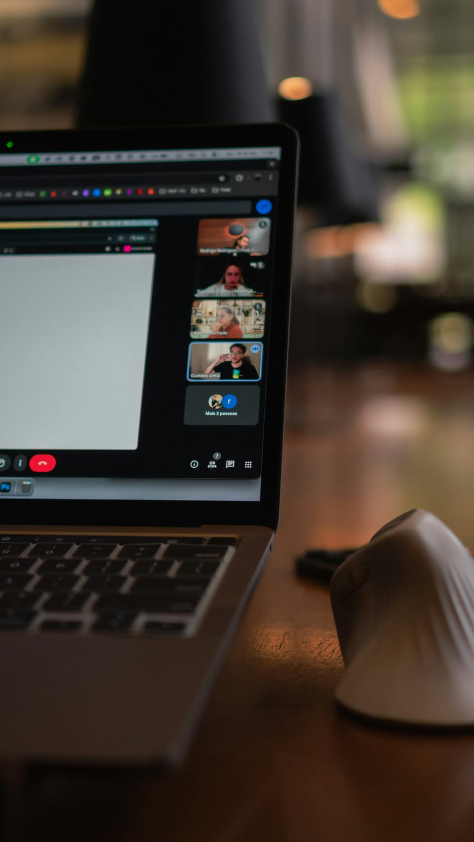 Laptop screen showing a video conference with multiple participants